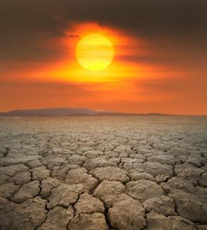 Parched soil and red Sun